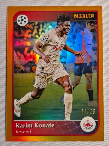 Karim Konate 2024 Panini Merlin UEFA Clubes Competiciones Naranja /25